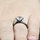 Enya's Black Plated Round Cut Engagement Ring