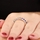 Kotien's Goldtone Eternity Ring - Blue CZ